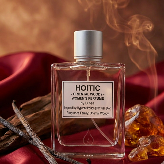 Perfume bottle labeled 'HOITIC' with vanilla beans and amber on a red fabric background